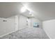 A finished attic with a sloped ceiling, carpeted floor, and access to other rooms at 2704 St Marys St, Raleigh, NC 27609