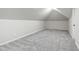 A spacious, carpeted attic with bright lighting and neutral walls, perfect for extra storage at 2704 St Marys St, Raleigh, NC 27609