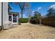 Backyard of the house with a grassy area, mature trees, and landscaping offering privacy at 2704 St Marys St, Raleigh, NC 27609