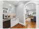 Bar with beverage cooler, sink, and access to other rooms at 2704 St Marys St, Raleigh, NC 27609