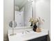 A well-lit bathroom featuring a vanity with a sleek mirror and stylish floral accents at 2704 St Marys St, Raleigh, NC 27609