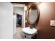 Charming bathroom featuring a pedestal sink with an oval mirror and decorative sconces at 2704 St Marys St, Raleigh, NC 27609