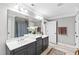 Bathroom with dual sinks, modern fixtures, and a large framed mirror at 2704 St Marys St, Raleigh, NC 27609