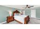 Comfortable bedroom with ornate wood furniture and stylish blue accent pillows at 2704 St Marys St, Raleigh, NC 27609