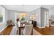 Bright dining room features a wooden table set for six with views to an outdoor living space at 2704 St Marys St, Raleigh, NC 27609