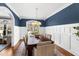 Elegant dining room featuring a long wooden table, stylish chandelier, and wainscoting at 2704 St Marys St, Raleigh, NC 27609