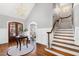 Grand entryway with a chandelier, staircase, hardwood floors, and arched entryways at 2704 St Marys St, Raleigh, NC 27609