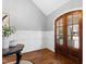 Welcoming entryway featuring hardwood floors, wainscoting, and an arched doorway at 2704 St Marys St, Raleigh, NC 27609