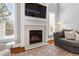 Living room fireplace with stone surround, built-in shelving, and a mounted television at 2704 St Marys St, Raleigh, NC 27609