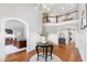 Open foyer with hardwood floors, arched doorways, chandelier, and view of the upper level at 2704 St Marys St, Raleigh, NC 27609