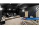Fun entertainment room with leather chairs, basketball game, and a sleek, dark ceiling at 2704 St Marys St, Raleigh, NC 27609