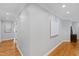 Hallway with wood floors, decorative moldings, and white walls at 2704 St Marys St, Raleigh, NC 27609