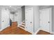 Hallway with wood floors and several doors for easy room access at 2704 St Marys St, Raleigh, NC 27609