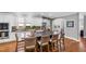 Bright kitchen with white cabinetry, center island with seating, and hardwood floors at 2704 St Marys St, Raleigh, NC 27609