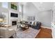 Spacious living room with a fireplace, large sectional sofa, and soaring ceilings at 2704 St Marys St, Raleigh, NC 27609