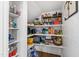 Organized walk-in pantry featuring shelving stocked with various food items and essentials at 2704 St Marys St, Raleigh, NC 27609