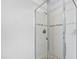 Clean bathroom shower featuring clear glass door and tiled surround at 2704 St Marys St, Raleigh, NC 27609