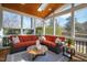Bright sunroom with a wooden ceiling, comfortable seating, and views of the landscaped backyard at 2704 St Marys St, Raleigh, NC 27609