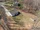 Aerial view of a two story home with a shed and fire pit surrounded by lush trees at 302 Weaver Ridge Rd, Rougemont, NC 27572