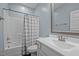 Bathroom with a vanity sink, bathtub, and shower featuring a neutral patterned curtain at 302 Weaver Ridge Rd, Rougemont, NC 27572