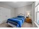 Cozy bedroom featuring a metal bed frame with a comfortable blue and white striped comforter at 302 Weaver Ridge Rd, Rougemont, NC 27572