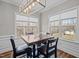 Bright dining area featuring large windows, modern lighting, and elegant finishes at 302 Weaver Ridge Rd, Rougemont, NC 27572