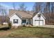 Charming exterior elevation with a two-car garage, a manicured lawn, and a cozy front porch with seating at 302 Weaver Ridge Rd, Rougemont, NC 27572