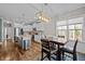 Modern kitchen featuring stainless steel appliances, an island with bar seating, and a dining area with natural light at 302 Weaver Ridge Rd, Rougemont, NC 27572