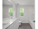Bathroom featuring a double sink vanity, modern fixtures, and tile flooring at 303 Old Fashioned Way, Lillington, NC 27546