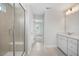 Bathroom with tiled floor features a glass enclosed shower with bench, and double sink vanity at 303 Old Fashioned Way, Lillington, NC 27546