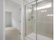 View of shower with glass door, tile surround and bench from bathroom doorway at 303 Old Fashioned Way, Lillington, NC 27546