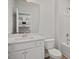 Bathroom with a single sink vanity and white tiled bathtub with shower at 303 Old Fashioned Way, Lillington, NC 27546