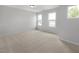 Empty bedroom with neutral carpet and large windows providing natural light at 303 Old Fashioned Way, Lillington, NC 27546
