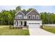 Charming two-story home featuring a welcoming front porch and a two-car garage at 303 Old Fashioned Way, Lillington, NC 27546