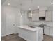 Modern kitchen features a spacious island, stainless steel appliances, and sleek white cabinetry at 303 Old Fashioned Way, Lillington, NC 27546