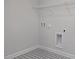 Convenient laundry room with patterned floors and essential hookups at 303 Old Fashioned Way, Lillington, NC 27546