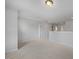 Open loft area features carpet and multiple doorways to other rooms at 303 Old Fashioned Way, Lillington, NC 27546