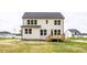 Rear exterior featuring a two-story house, showing a wooden deck and freshly laid lawn in a suburban neighborhood at 303 Old Fashioned Way, Lillington, NC 27546
