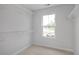 Walk-in closet with wire shelving and a window overlooking the front yard at 303 Old Fashioned Way, Lillington, NC 27546