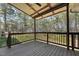 Wide shot of a wooded backyard including a small play area at 325 Cobblestone Dr, Spring Lake, NC 28390