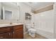 Bathroom featuring a vanity with storage, a toilet, and a shower-tub combo at 325 Cobblestone Dr, Spring Lake, NC 28390