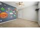 Spacious bedroom featuring a ceiling fan and fun space-themed mural on the wall at 325 Cobblestone Dr, Spring Lake, NC 28390