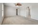 Neutral bedroom showcasing a ceiling fan, light walls, carpet, and doorways to connecting rooms at 325 Cobblestone Dr, Spring Lake, NC 28390
