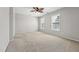 Bright bedroom with neutral carpet, light walls, a ceiling fan, and abundant natural light from large windows at 325 Cobblestone Dr, Spring Lake, NC 28390