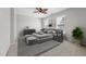 Comfortable bedroom features a decorative ceiling fan, large windows, and stylish furnishings at 325 Cobblestone Dr, Spring Lake, NC 28390