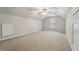 Large bonus room featuring neutral carpet, a ceiling fan, and a single window offering natural light at 325 Cobblestone Dr, Spring Lake, NC 28390