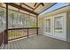 Covered deck with wood flooring, wood railing, and beautiful wooded views at 325 Cobblestone Dr, Spring Lake, NC 28390