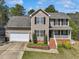 Charming two-story home featuring neutral siding, black shutters, and an attached two-car garage at 325 Cobblestone Dr, Spring Lake, NC 28390