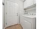 Functional laundry room featuring a washer, dryer, shelving, and cabinet storage for convenience at 325 Cobblestone Dr, Spring Lake, NC 28390