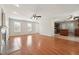 Open-concept living room with fireplace flowing into the kitchen with hardwood floors and a ceiling fan at 325 Cobblestone Dr, Spring Lake, NC 28390